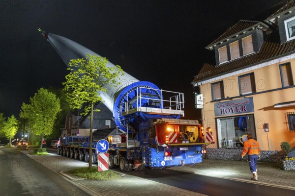 Transport of a 68 metre long, 22 tonne blade of a wind turbine, here in Breckerfeld-Waldbauer, with a self-propelled Blade-Lifter vehicle, over a 40 km long route, over 2 nights, in the Bergisches Land, through towns, villages, on country roads, narrow through roads, to the construction site of the wind turbine near Hagen, North Rhine-Westphalia, Germany, Europe