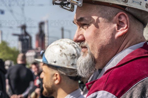 Steelworkers at a demonstration in front of the headquarters of ThyssenKrupp Steel Europe in Duisburg, against massive job cuts, after the participation of a foreign investor in the group, in the background the blast furnaces 8 and 9, Duisburg North Rhine-Westphalia, Germany, Europe