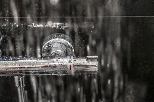 Shower, fitting, temperature control, temperature control of the shower water