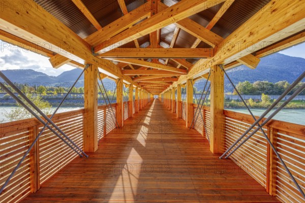 Symmetrical interior view of a wooden bridge with a view of the river and mountains, Inn footbridge, bridge over the Inn