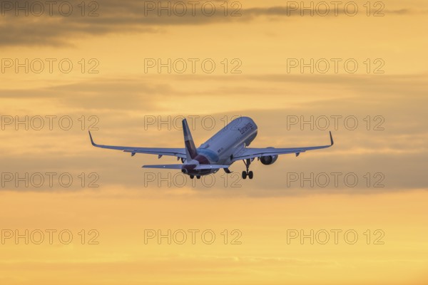 Passenger aircraft in front of a cloudy morning sky, sunrise, Eurowings, Baden-Württemberg, Germany, Europe