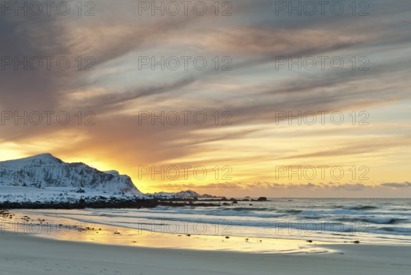 Sunset in winter at Skagsanden, stones on the beach at Flakstad, Flakstadøy, Lofoten, Nordland, Norway, Europe