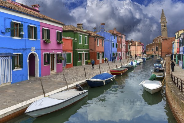 Colourful houses on the canal, behind the leaning tower of the church of St. Martin Vescovo, 16th century, Burano, Venice, Veneto, Italy, Europe