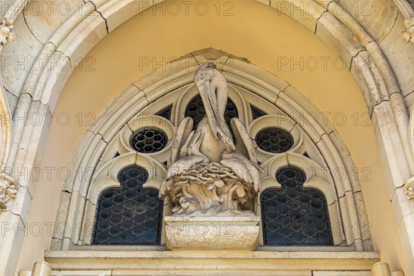 Pelican as a Christian symbol above the entrance gate to the Jakobikirche, Freiberg, Saxony, Germany, Europe