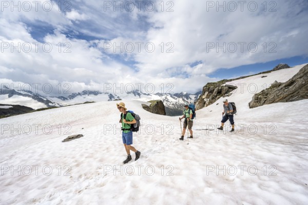 Three mountaineers crossing a snowfield, ascent to the Nördliche Mörchnerscharte, Berliner Höhenweg, Zillertal Alps, Tyrol, Austria, Europe