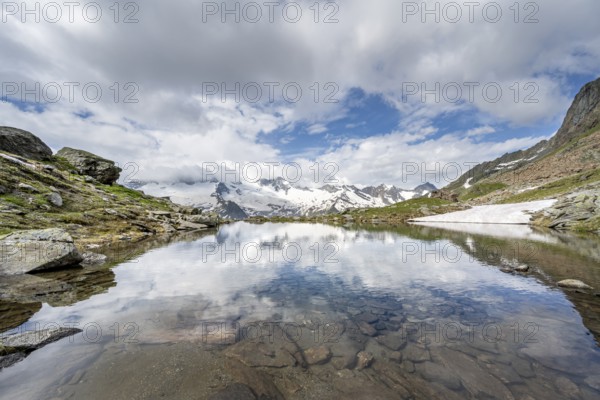 Picturesque mountain landscape with mountain lake, mountains and glaciers reflected in the Schwarzsee, Hornkees and Waxeggkees glaciers with Großer Möseler peak, Berliner Höhenweg, Zillertal Alps, Tyrol, Austria, Europe