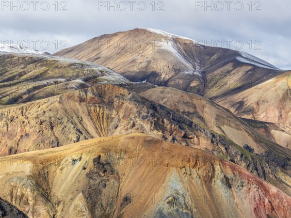 Early snow on the colorful rhyolite mountains, mt. Brennisteinsalda, lava fields, Landmannalaugar, Fjallabak Nature Reserve, Iceland, Europe