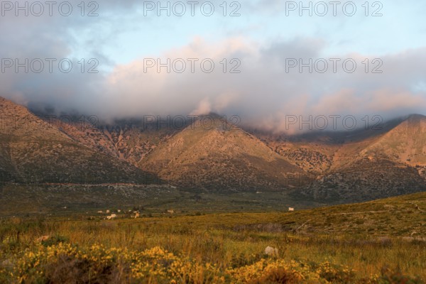 Mountain landscape at dusk with clouds enveloping the peaks in a tranquil rural setting, Itylo, Anatoliki Mani, Mani, Laconia, Peloponnese, Greece, Europe
