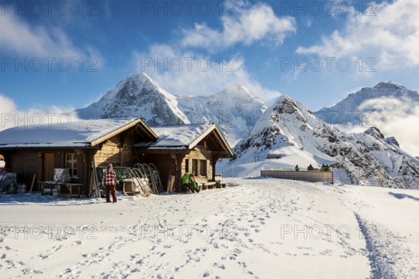 Wooden chalet and ski slope, with views of the Eiger, Mönch and Tschuggen, Grindelwald, Bernese Alps, Canton of Bern, Switzerland, Europe