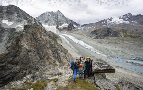 Group of mountaineers at Col de Riedmatten, view of glacier Glacier de Cheilon and mountain peak Mont Blanc de Cheilon, Valais, Western Alps Switzerland