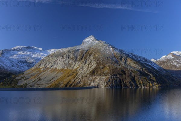 Kölnbrein reservoir and the Oberlecherspitzen mountain on a bright sunny morning. Seen from the Malta Hochalm road. Carithia, Austria, Europe