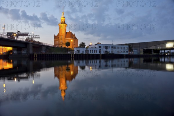 The old harbour office in the neo-renaissance style in the harbour in Dortmund at dusk, North Rhine-Westphalia, Germany, Europe