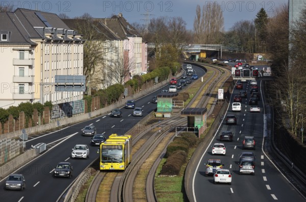 Essen, North Rhine-Westphalia, Germany - Cars and a public bus drive through Essen city centre on the A40 motorway