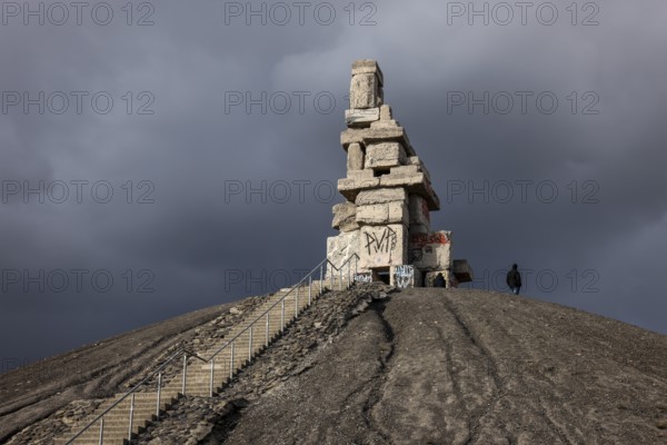 Gelsenkirchen, North Rhine-Westphalia, Germany - Rheinelbe slagheap with artwork Himmelstreppe made of old concrete parts of the former Rheinelbe colliery in front of a dark sky, artist Herman Prigann