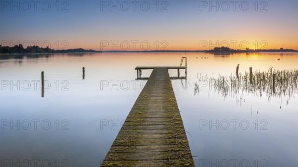 Wooden footbridge at sunrise on Lake Schaalsee, Schaalsee Biosphere Reserve, Zarrentin, Mecklenburg-Western Pomerania, Germany, Europe