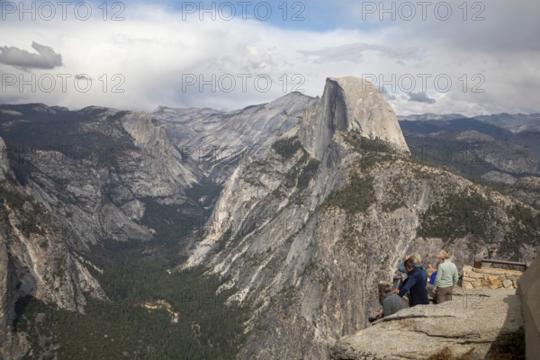 Yosemite National Park, California - Tourists viewing Half Dome in Yosemite National Park from Glacier Point