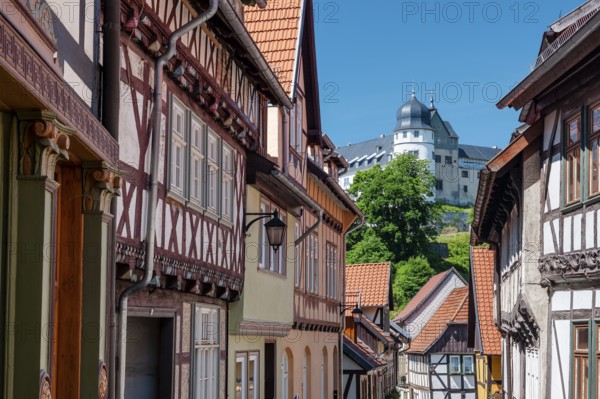 Street with half-timbered houses in the old town, the castle in the background, Stolberg im Harz, Saxony-Anhalt, Germany, Europe