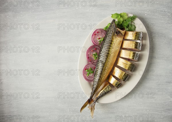 Smoked mackerel, top view, with spices, on a wooden table, no people, selective focus