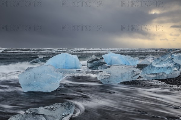 Ice floes on the beach, waves, sea, clouds, sunlight, winter, Diamond Beach, Breidamerkursandur, Jökulsarlon, Iceland, Europe