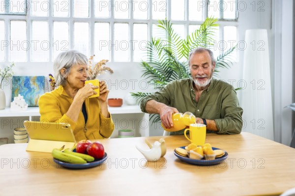 Frontal view of a caucasian mature couple having pleasant healthy breakfast together