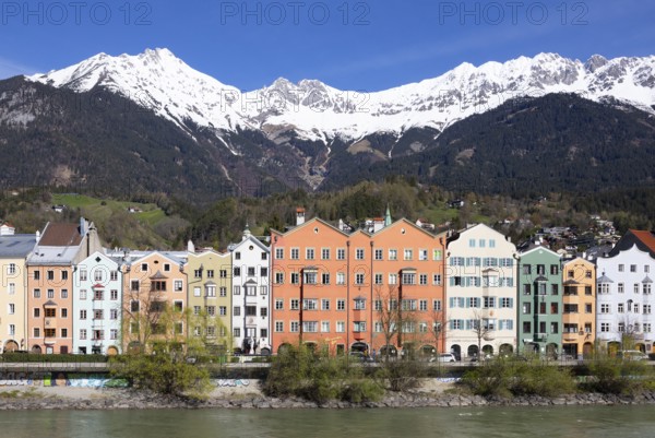 Colourful buildings along the Inn river with snow-covered Nordkette in the background, Karwendel mountains, Innsbruck, Tyrol, Austria, Europe