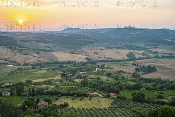 View from Montepulciano into a typical Tuscan landscape in Val d'Orcia with hills, trees, fields, cypresses and farm houses in summer, Montepulciano, Tuscany, Italy, Europe