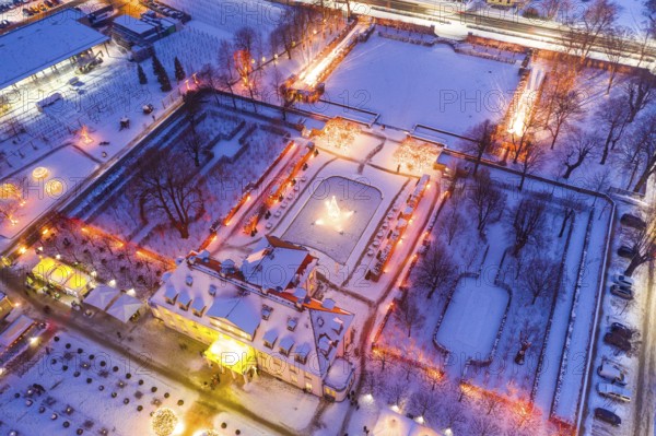 Aerial view of Wackerbarth Castle with castle park in snow and Christmas lights, Radebeul, Saxony, Germany, Europe