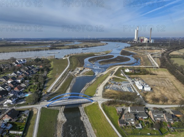 Dinslaken, Voerde, North Rhine-Westphalia, Germany - New Emscher estuary into the Rhine. Renaturalisation of the Emscher. Flood protection through land expansion. The decommissioned STEAG Voerde coal-fired power station in the background. The mouth of the Emscher into the Rhine was moved almost 500 metres north from Dinslaken to Voerde. Fish can now swim barrier-free up the new Emscher from the Rhine through a newly created floodplain area. Following the construction of a parallel sewer, the Emscher has been completely free of sewage since January 2022. The river was previously an open, above-ground combined sewer with rainwater and wastewater