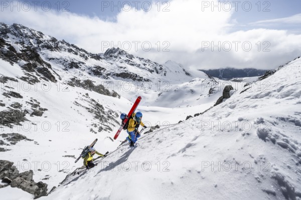 Climbers with skis ascending a steep snow slope to the Porta d'Es-cha saddle, Bündner Haute Route ski tour, Albula Alps, Rhaetian Alps, Grisons, Eastern Switzerland, Switzerland, Europe