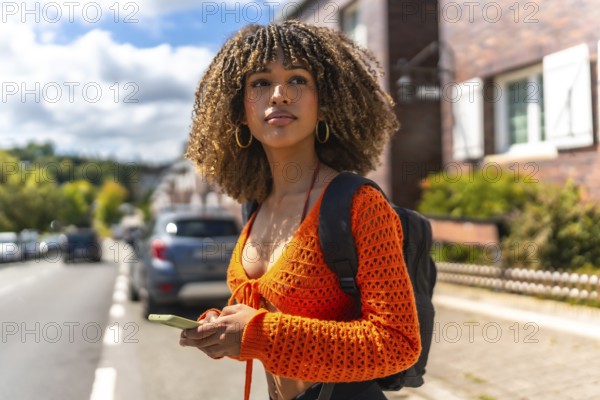 Side view of a beauty young latin woman using the gps of the phone to get directions in the city