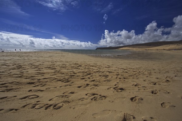Beach Playa Risco del Paso, Playa de Sotavento with footprints in front of a cloudy blue sky, Pajara, Fuerteventura, Canary Islands, Spain, Europe