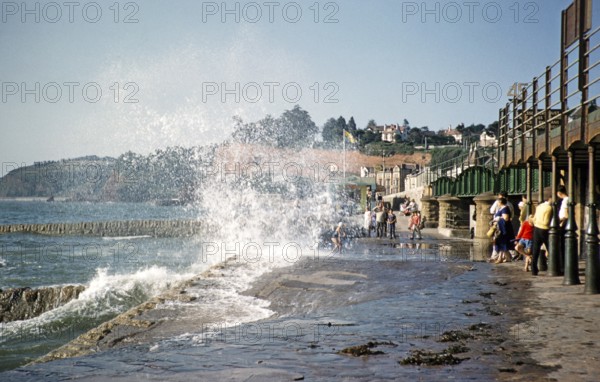 Waves of the rough sea hit the promenade near the railway station, Dawlish, Devon, England, United Kingdom, early 1960s, Europe