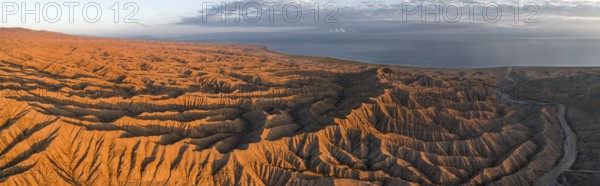 Landscape of eroded hills at Lake Issyk Kul, Badlands at sunrise, aerial view, Canyon of the Forgotten Rivers, Issyk Kul, Kyrgyzstan, Asia