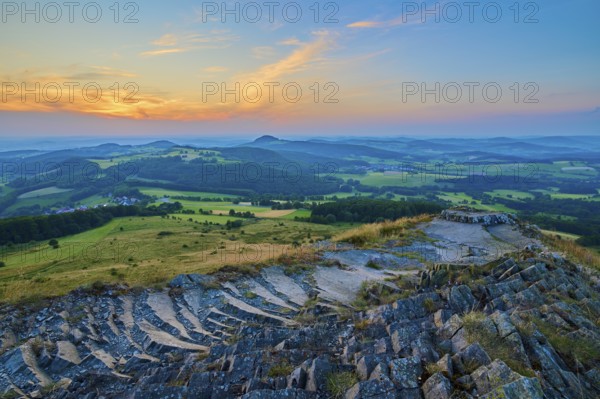 Colourful hilly landscape at sunset, showing fields and a dramatically coloured sky, Abtsroder Kuppe, Abtsroda, Wasserkuppe, Rhön, Hesse, Germany, Europe