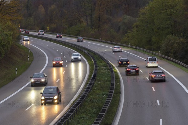 Traffic on a wet motorway at dusk, surrounded by trees, Rems-Murr district, Baden-Württemberg, Germany, Europe