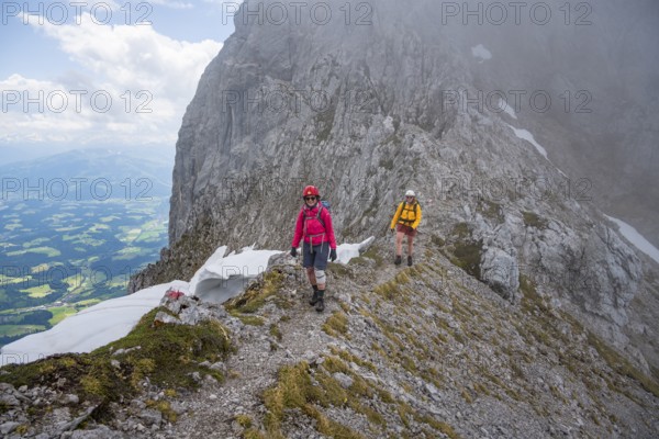 Two mountaineers with helmets in the mountains in fog, Wilder Kaiser, Kaiser Mountains, Tyrol, Austria, Europe