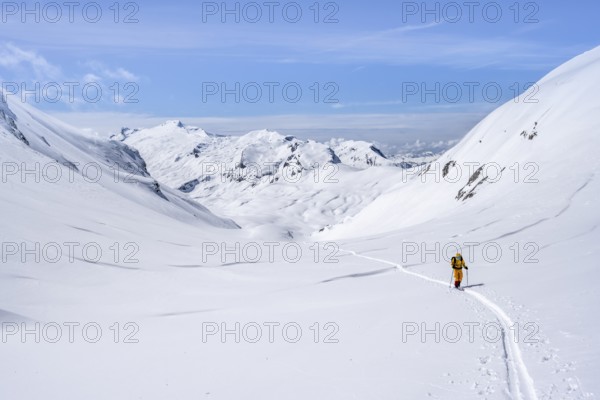 Lone ski tourer in a mountain landscape with snow, summit Wildhorn in the background, ascent to Wildstrubelhütte, Bernese Alps, Switzerland, Europe