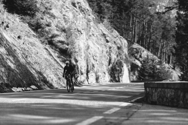 Road bike rider in spring between Lechtal and Tannheimer Tal in front of picturesque scenery of the Alps, Tyrol, Austria, Europe