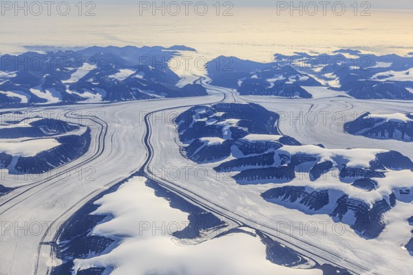 Aerial view of glaciers, glacier tongues and icy mountains on the coast, sunny, East Greenland, Greenland, North America