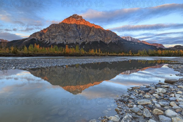 Clouds and evening light over mountains, mountain reflected in water, autumn, Brooks Range, Alaska, USA, North America