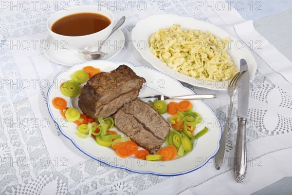 Swabian cuisine, roast beef, roast ox, herb spaetzle, meat dish, gravy, carrot vegetables, leek, serving platters, hearty, savoury, typical Swabian, home cooking, traditional cuisine, food photography, studio, Germany, Europe