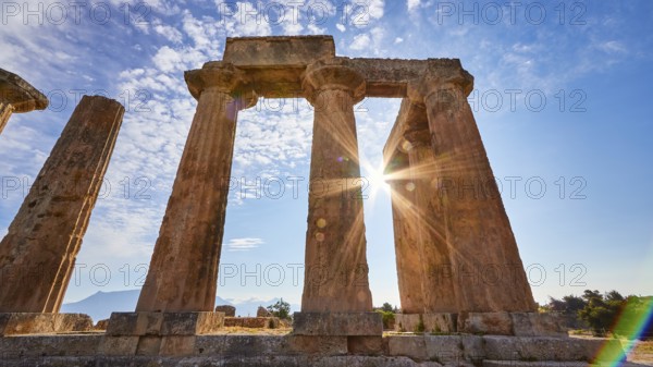 Archaic Temple of Apollo, Doric columns, Rays of light breaking through the columns of a ruined temple on a sunny day, Archaeological site, Archea Korinthos, Corinth, Peloponnese, Greece, Europe