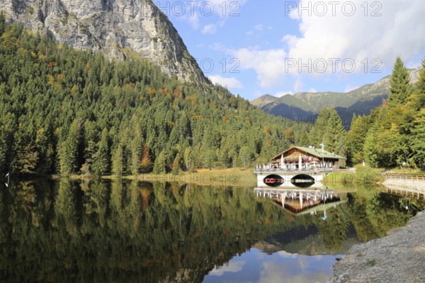 The picturesque Pflegersee lake near Garmisch, with the mountain inn in the background