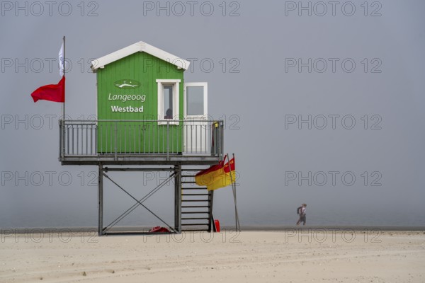North Sea island of Langeoog, early summer, shortly after the first easing of the lockdown in the Corona crisis, foggy weather, still quite few tourists on the beach, DLRG watchtower, Lower Saxony, Germany, Europe