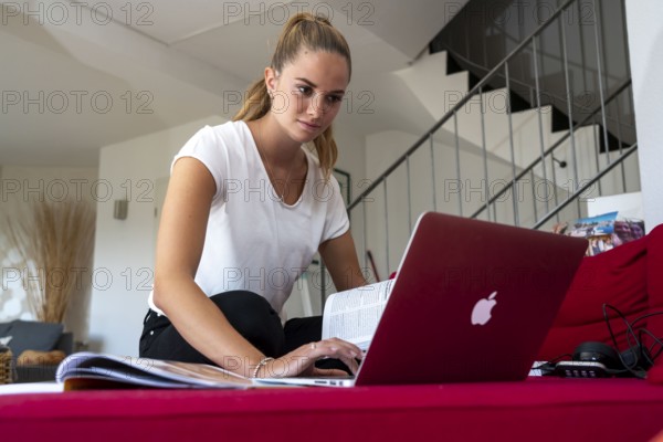 Young student learns at home, online, on her notebook