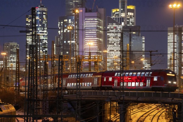 Railway tracks in front of the main railway station in Frankfurt am Main, skyline of skyscrapers in the Cit, winter, snow, dusk, Hesse, North Rhine-Westphalia