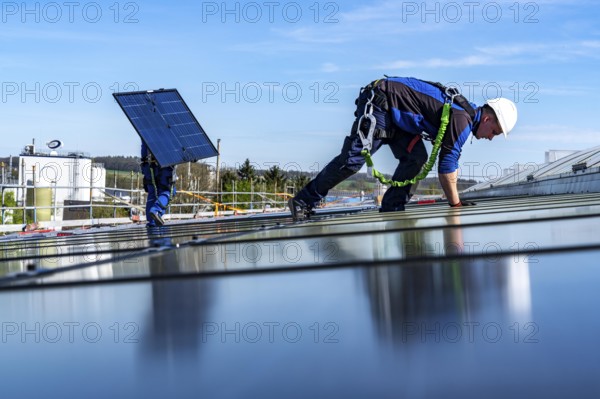 Installation of solar modules on the roof of a commercial enterprise, over 400 photovoltaic modules are installed on the roof, North Rhine-Westphalia, Germany, Europe