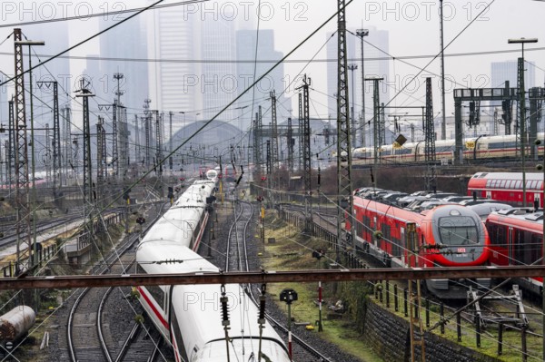 Railway tracks with regional and long-distance trains, ICE, after freezing rain, in front of Frankfurt main station, skyline in the fog, Hesse, Germany, Europe