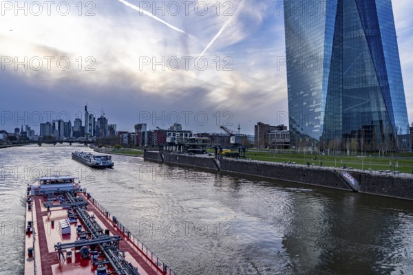 Skyline of Frankfurt am Main, skyscrapers, business and banking district in the city centre, cargo ships, tankers, on the river Main, ECB building, Hesse, Germany, Europe
