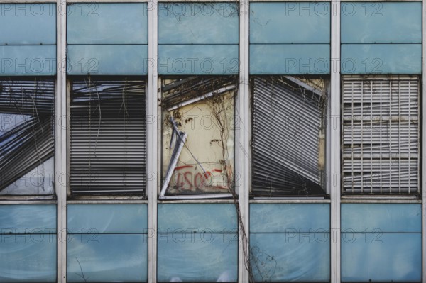 Broken windows and shutters of an abandoned office building loom in Berlin, 29/02/2024